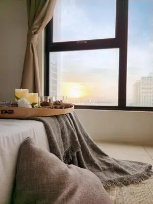 a table with a tray of candles and a window at NEW 2BR Sunrise Gurney with Stunning Seaview \u65e0\u654c\u65e5\u51fa\u6d77\u666f\u623f in George Town