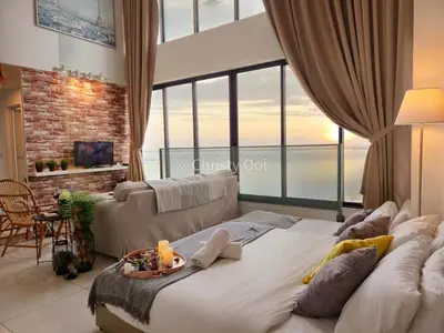 a large bed in a living room with a large window at NEW 2BR Sunrise Gurney with Stunning Seaview \u65e0\u654c\u65e5\u51fa\u6d77\u666f\u623f in George Town