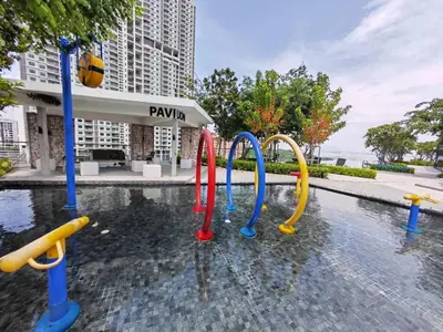 a pool of water with a playground in front of a building at Georgetown 2BR Luxury Condo Unbeatable Night View Infinity Pool Attractions Food Fully Equipped#148B in Bayan Lepas