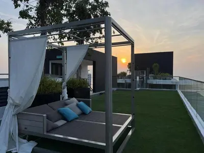 a gazebo with a couch on a patio at Stylish city center infinity pool unbeatable night view near to attractions, food, family friendly in Jelutong