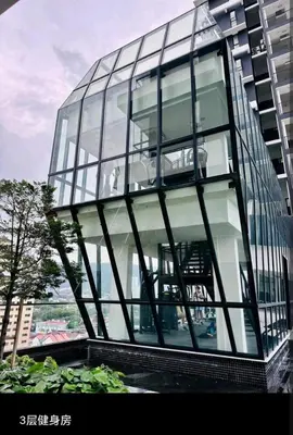 a glass office building with a revolving window at Stylish city center infinity pool unbeatable night view near to attractions, food, family friendly in Jelutong