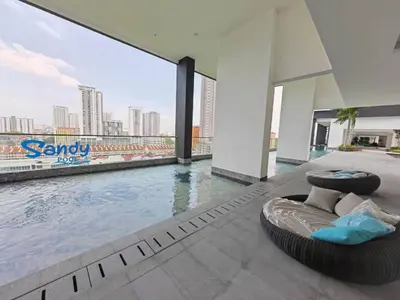a swimming pool with a circular bed next to a building at Stylish city center infinity pool unbeatable night view near to attractions, food, family friendly in Jelutong