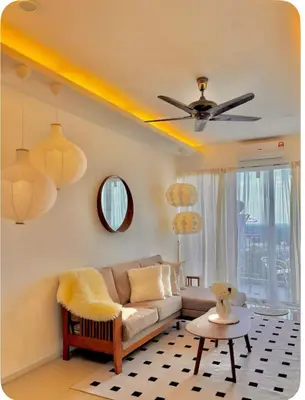 a living room with a couch and a ceiling fan at Dandelion 3BR Apt Near lake garden in Taiping