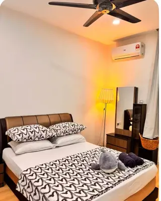 a bedroom with a bed with a ceiling fan and a mirror at Dandelion 3BR Apt Near lake garden in Taiping