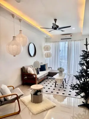a living room with a couch and a christmas tree at Dandelion 3BR Apt Near lake garden in Taiping