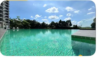 a large swimming pool with turquoise water at Dandelion 3BR Apt Near lake garden in Taiping