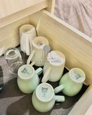 a group of teapots sitting in a drawer at CozyVista Suites Marina Island Lumut Perak in Gua Sai