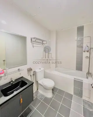 a bathroom with a sink and a toilet and a bath tub at CozyVista Suites Marina Island Lumut Perak in Gua Sai