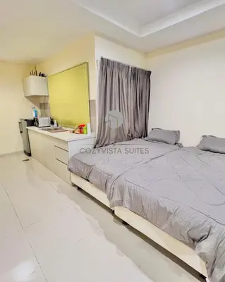 a bedroom with a large bed and a sink at CozyVista Suites Marina Island Lumut Perak in Gua Sai