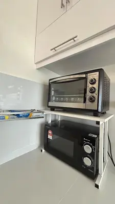 a microwave sitting on a shelf in a kitchen at Mimi's Nest - Fully furnished, wifi at Tronoh in Teronoh