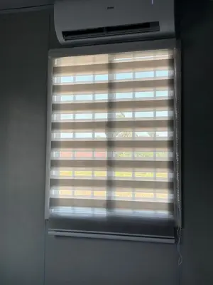a window with the blinds on it in a room at Roomstay Kontena Sungai Bioh in Gua Sai