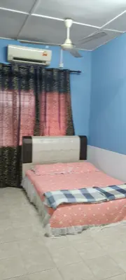 a bed in a room with a curtain at Homestay Bonda D' in TanjongMalim