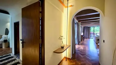 a hallway of a house with a vase on a table at Room 11 by 10 Mentigi in Tanah Rata