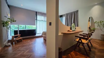 a living room with a table and chairs and a television at Room 11 by 10 Mentigi in Tanah Rata