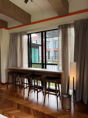 a dining room with a table and chairs and a large window at Room 11 by 10 Mentigi in Tanah Rata