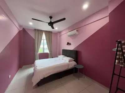 a bedroom with pink walls and a bed with a ceiling fan at Palette & Pool Haven in Ipoh