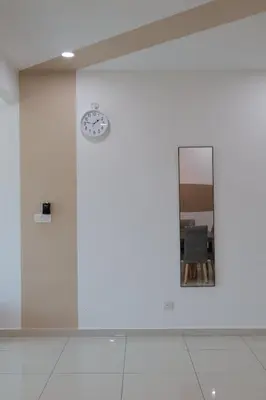 a white wall with a clock and a mirror at Palette & Pool Haven in Ipoh