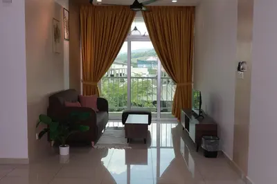 a living room with a chair and a window at Palette & Pool Haven in Ipoh