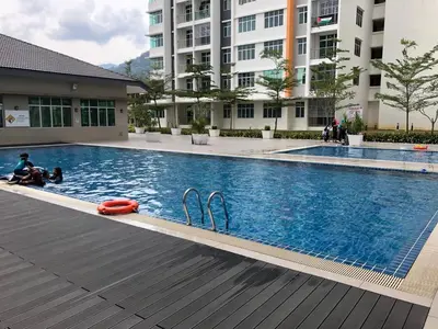 a swimming pool with two flip flops in a building at Palette & Pool Haven in Ipoh