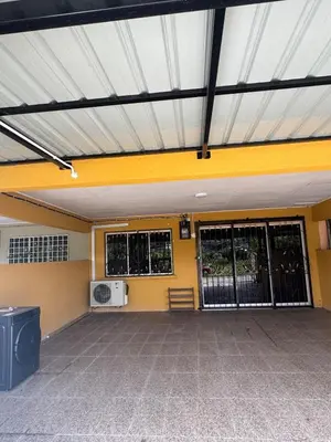 an empty parking lot with a yellow wall at Homestay NIA Chukai in Gua Sai