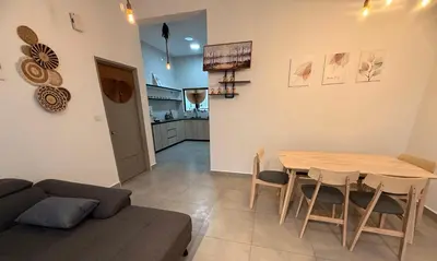 a living room with a table and a couch at 2 Storey Terrace 39 night market in Brinchang