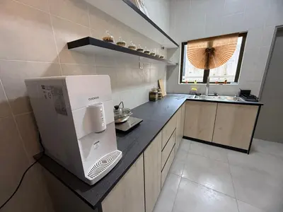 a kitchen with a white refrigerator on a counter at 2 Storey Terrace 39 night market in Brinchang