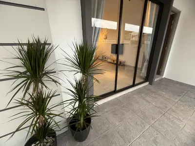 two potted plants in a room with a window at 2 Storey Terrace 39 night market in Brinchang