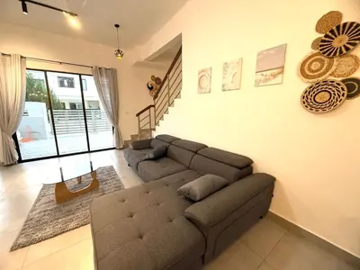 a living room with a sectional couch and a living room at 2 Storey Terrace 39 night market in Brinchang