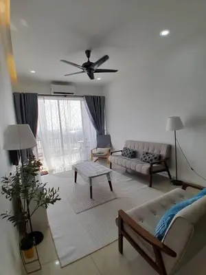 a living room with a couch and a table at Condominium Crystal Heights in Taiping