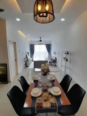 a dining room table and chairs in a living room at Condominium Crystal Heights in Taiping