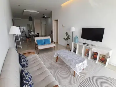 a living room with a couch and a flat screen tv at Condominium Crystal Heights in Taiping