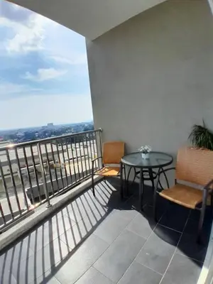 a balcony with a table and chairs and a view at Condominium Crystal Heights in Taiping