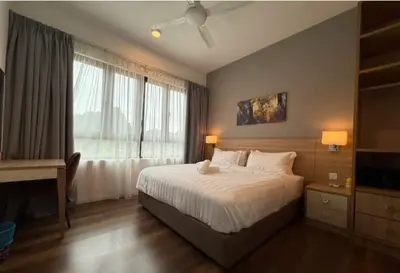 a bedroom with a large bed and a window at Sunway Onsen Theme Park View Ipoh in Ipoh