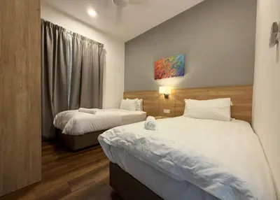 a hotel room with two beds and a window at Sunway Onsen Theme Park View Ipoh in Ipoh
