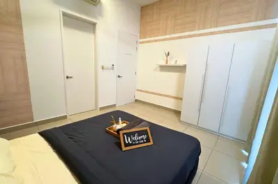 a room with a bed with a sign on it at Sunset View Stay at Conezion IOI in Gua Sai