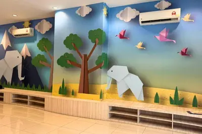a wall mural in a waiting room with animals and birds at Sunset View Stay at Conezion IOI in Gua Sai