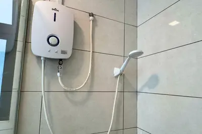 a white phone on the side of a wall at Sunset View Stay at Conezion IOI in Gua Sai