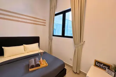 a small bedroom with a bed and a window at Sunset View Stay at Conezion IOI in Gua Sai