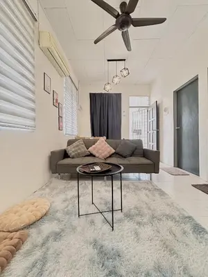a living room with a couch and a table at 11Acozy#6pax#singlestoreyhouseAlmaBukitMertajam in Bukit Mertajam