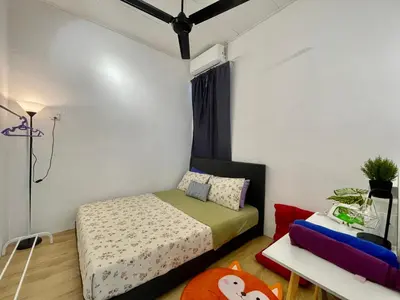 a small bedroom with a bed and a couch at 11Acozy#6pax#singlestoreyhouseAlmaBukitMertajam in Bukit Mertajam