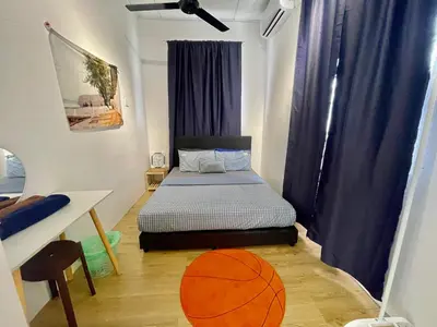 a bedroom with a bed and a basketball on the floor at 11Acozy#6pax#singlestoreyhouseAlmaBukitMertajam in Bukit Mertajam