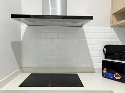 a stove top oven in a white kitchen at Iconic Regency Service Residences - Bee's Home in Bayan Lepas