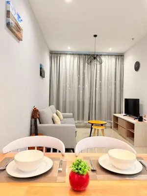 a living room with a table and chairs and a couch at Iconic Regency Service Residences - Bee's Home in Bayan Lepas