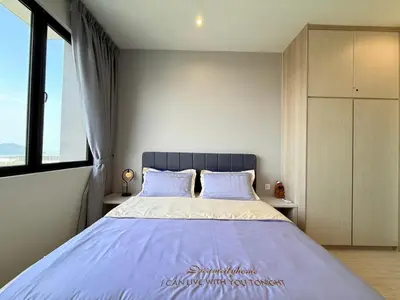 a bedroom with a large bed with a large window at Iconic Regency Service Residences - Bee's Home in Bayan Lepas