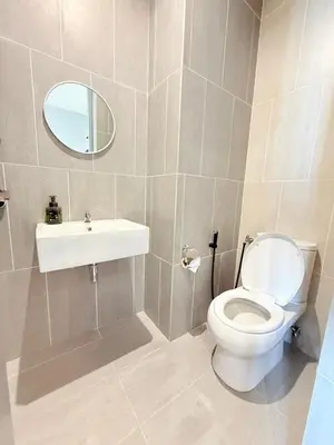 a bathroom with a toilet and a sink and a mirror at Iconic Regency Service Residences - Bee's Home in Bayan Lepas