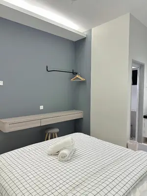 a bedroom with a bed with a phone on it at Tanah Rata Cameron Jaya cottage has plenty of hot water, a spacious living room in Tanah Rata