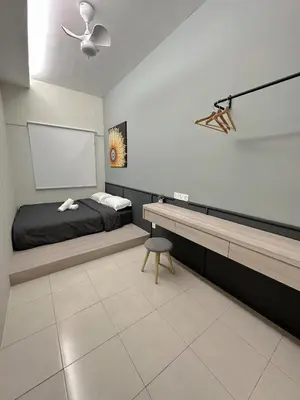a bedroom with a bed and a table and a chair at Tanah Rata Cameron Jaya cottage has plenty of hot water, a spacious living room in Tanah Rata