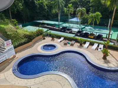 an overhead view of a swimming pool at a resort at Sri Sayang Resort Apartment in Batu Ferringhi