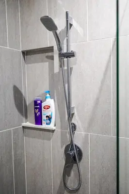 a shower with a shower head in a bathroom at IconicRegency #3BR #USM #Queensbay #Airport in Bayan Lepas