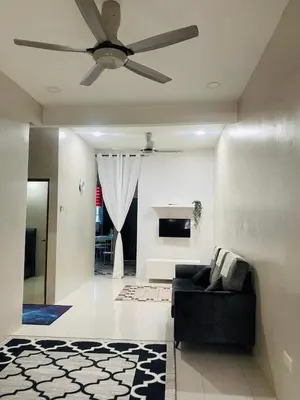 a living room with a ceiling fan and a couch at ZuLee Homestay in Lunas